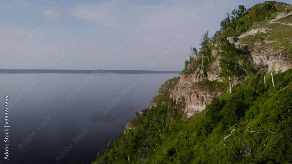 Flight along a picturesque cliff above the river. A huge reservoir and a steep stone cliff. Flight along a picturesque cliff above the river. A huge reservoir and a steep stone cliff.