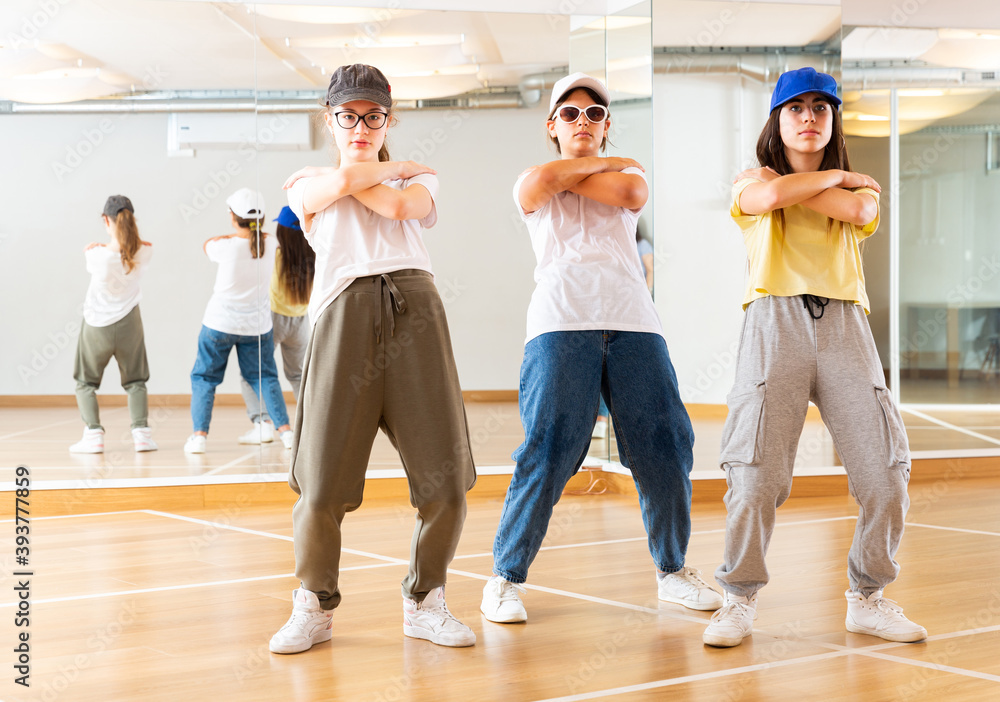 Fototapeta premium Focused teenage hip hop dancers doing dance workout during group class