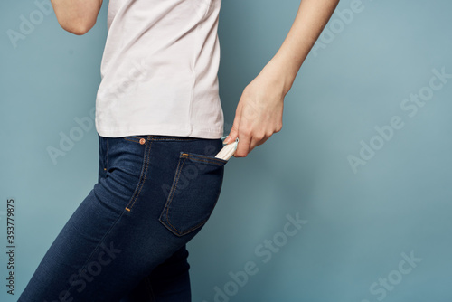 Woman with tampon and jeans t-shirt menstruation blue background cropped view hygiene © SHOTPRIME STUDIO