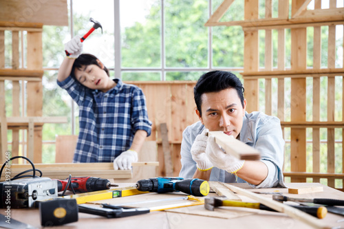 Father and son doing woodwork together.