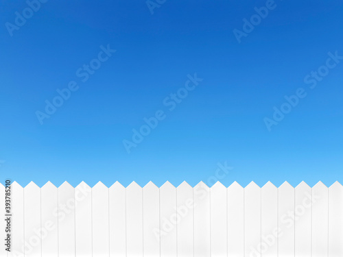 White wooden fence and on a clear blue sky background