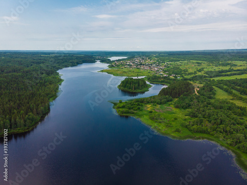 A beautiful large lake with an island. Lake Verkhopuiskoe. Velsky district
