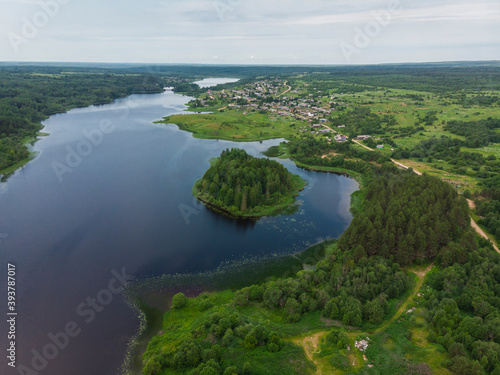 A beautiful large lake with an island. Lake Verkhopuiskoe. Velsky district photo