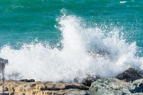 Canvas Print Waves of Persian Gulf splashing the stones of breakwater  at the crescent road in the Palm Jumeirah island in Dubai of the United Arab Emirates