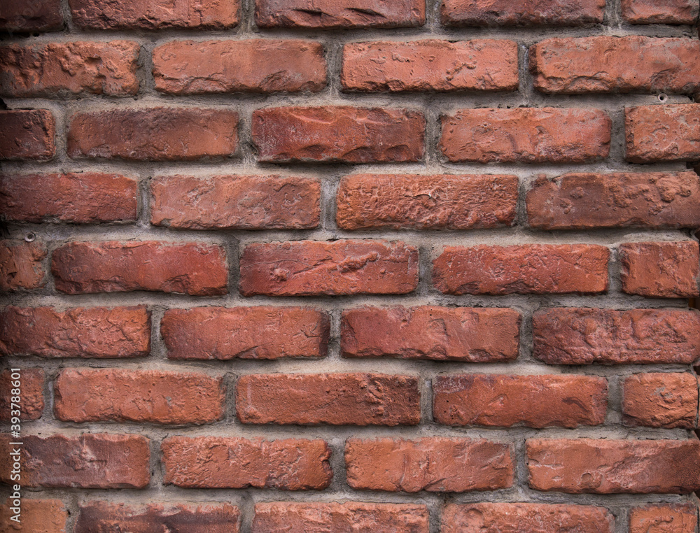 Fototapeta premium The surface texture of the retro red brick wal with grey concrete in the gaps.