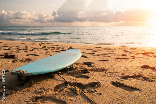 Photography Surfboard on sand at summer beach with sunset light.
