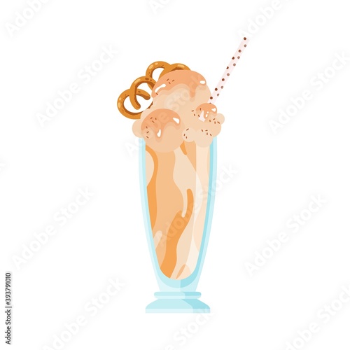 Glass of cold caramel milkshake decorated with pretzel. Frappe or milk cockta...