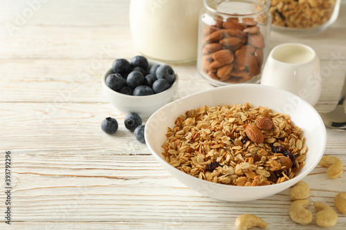Concept of tasty breakfast with granola on wooden background © Atlas