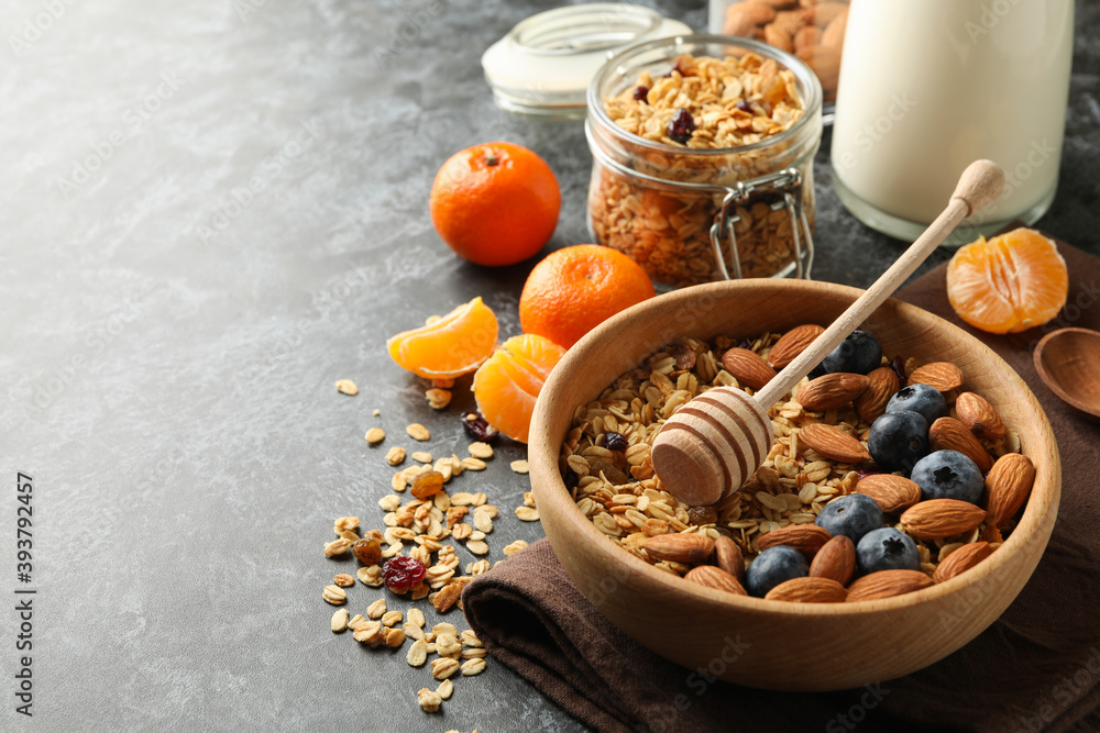 Fototapeta premium Concept of tasty breakfast with granola on black smokey background