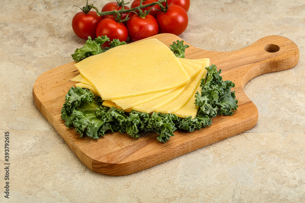 Sliced Gauda cheese over board Sliced Gauda cheese over board