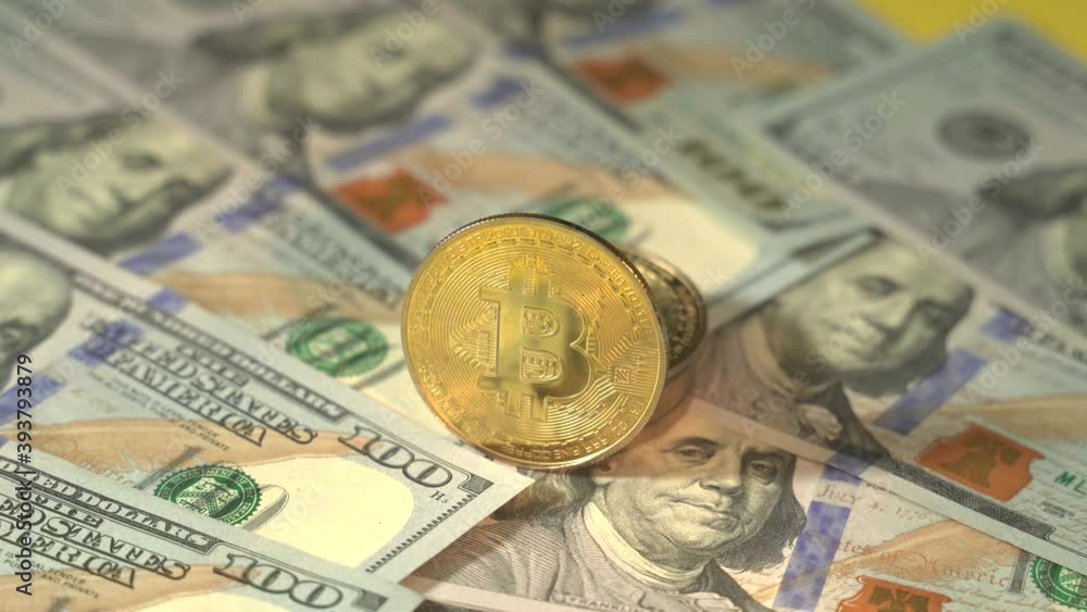 Digital economy and dollar, wheel turns concept. Gold bitcoin and cash. American powerful dollars banknotes and BTC. Yellow background. Blockchain technology. Mining and trade market concept Digital economy and dollar, wheel turns concept. Gold bitcoin and cash. American powerful dollars banknotes and BTC. Yellow background. Blockchain technology. Mining and trade market concept