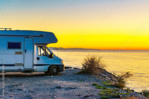 Rv camper camping on sea shore, Spain.