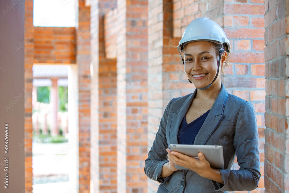 Female engineer holding tape and smiling