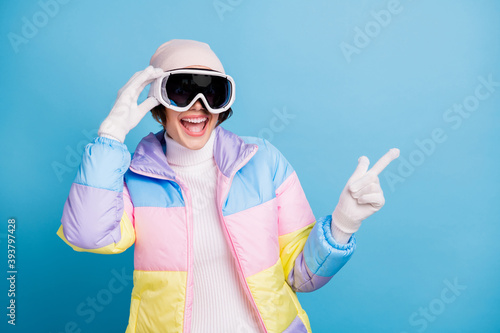 Photo of pretty amazed lady point finger copyspace wear hat white gloves mask isolated on blue color background