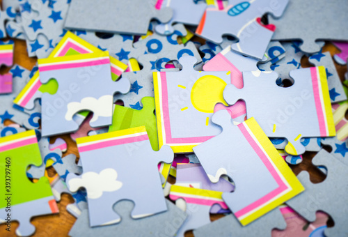 Close-up of colorful puzzles for children of different sizes lying on the floor