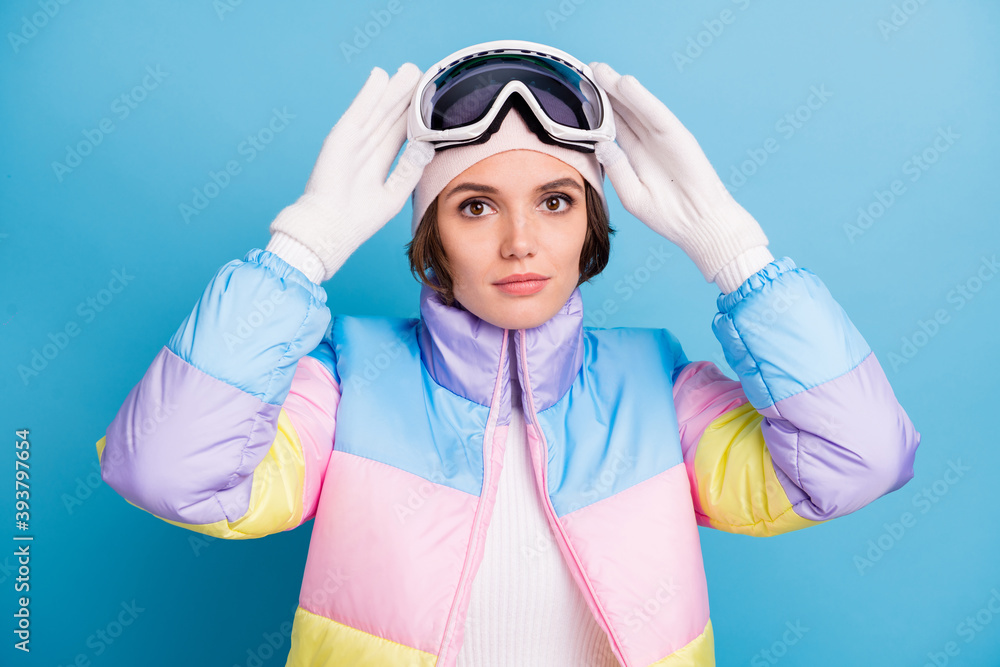 Photo of beautiful skier woman hold goggles mask extreme hobby winter season isolated on blue color background