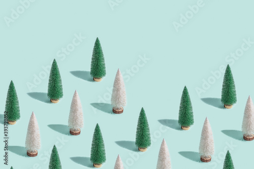 Creative Christmas pattern from Christmas tree on blue, New Year composition. Design for website, wrapping paper, wallpaper, screensaver. photo