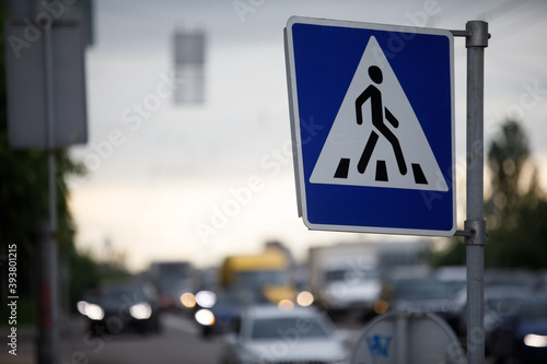 pedestrian crossing sign and cars in the background, sad and depressive