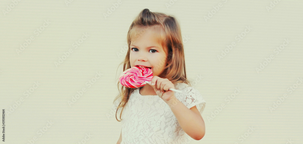 Portrait of cute little girl child with lollipop over background Portrait of cute little girl child with lollipop over background