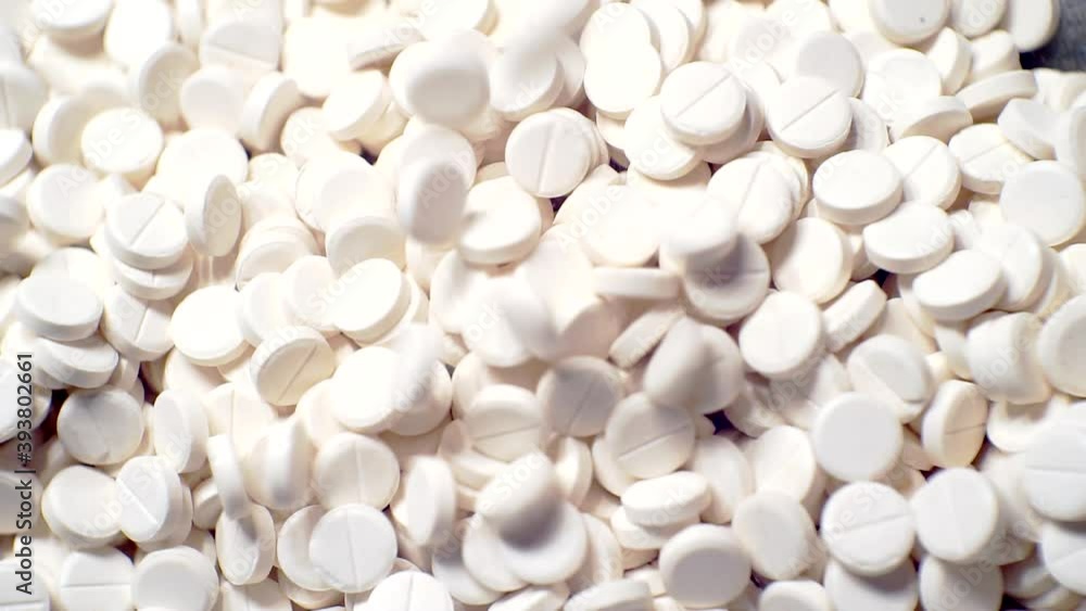modern pharmaceutical production.many white pills close up. modern pharmaceutical production.many white pills close up.