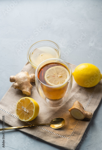 Healthy living herbal tea; lemon honey tea with ginger root on a gray background