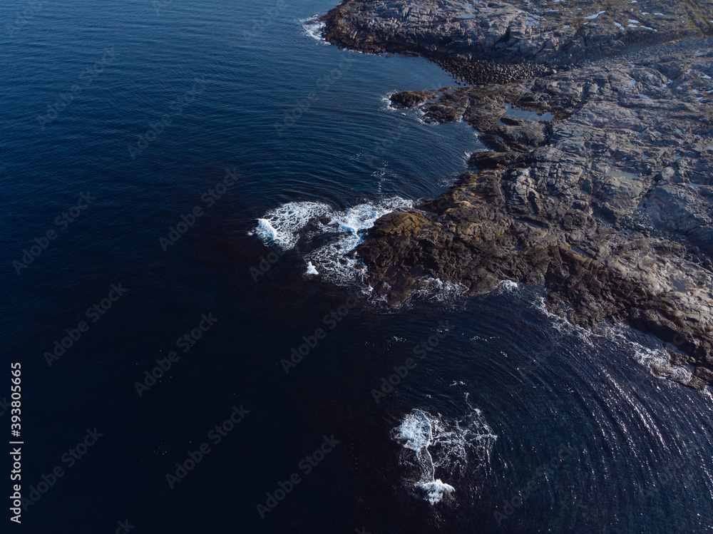 Top view aerial photo from flying drone of an amazingly beautiful sea landscape, blue water, rocky coast line. Barents Sea. Autumn in tundra, bright sunny day, vivid colors 