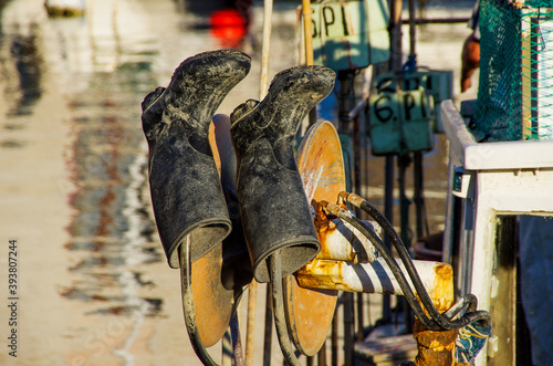 Boots hung for drying in mediterane harbour. High quality photo