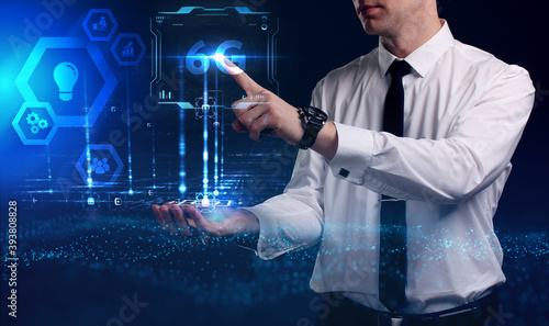 Business, Technology, Internet and network concept. Young businessman working on a virtual screen of the future and sees the inscription: 6G
