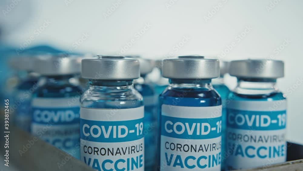 Container full of coronavirus vaccine vials. Concept of Coronavirus Vaccination People. Pharmacology Drugs against Pandemic Covid-19. Medical Vaccine bottle from Global Danger 2019-ncov. Container full of coronavirus vaccine vials. Concept of Coronavirus Vaccination People. Pharmacology Drugs against Pandemic Covid-19. Medical Vaccine bottle from Global Danger 2019-ncov.