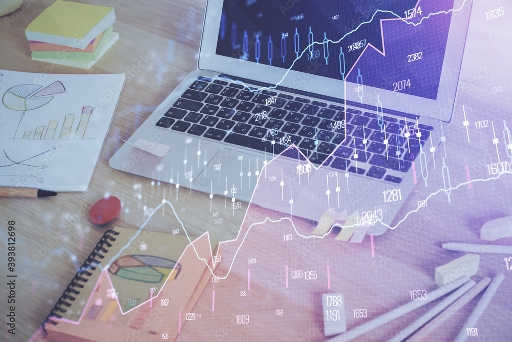 Financial graph colorful drawing and table with computer on background. Multi exposure. Concept of international markets. Financial graph colorful drawing and table with computer on background. Multi exposure. Concept of international markets.