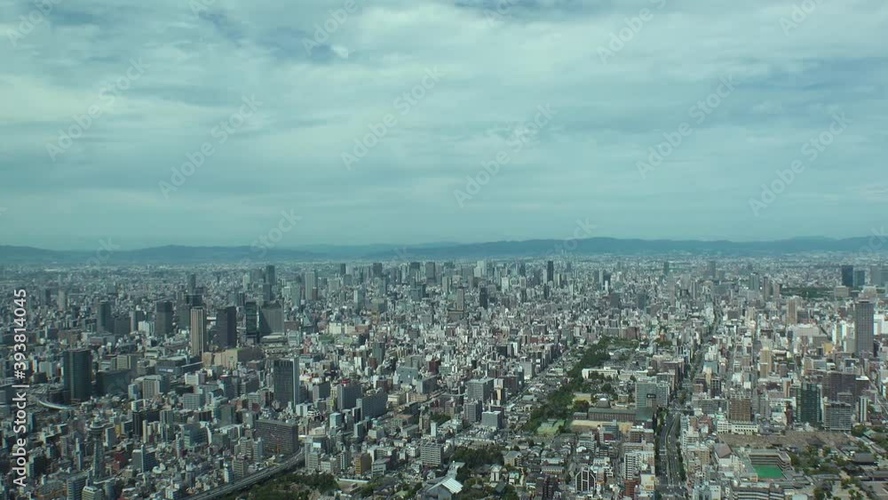 OSAKA, JAPAN : Aerial high angle view of CITYSCAPE of OSAKA in day time. View of buildings and streets around Namba, Shinsaibashi, Umeda and Osaka train station. Wide view time lapse tracking shot. OSAKA, JAPAN : Aerial high angle view of CITYSCAPE of OSAKA in day time. View of buildings and streets around Namba, Shinsaibashi, Umeda and Osaka train station. Wide view time lapse tracking shot.