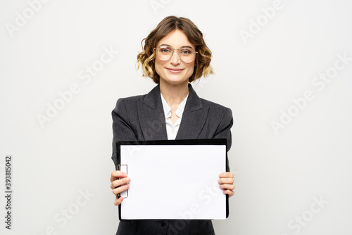 Business woman with a folder of documents on a light background cropped view and shirt suit