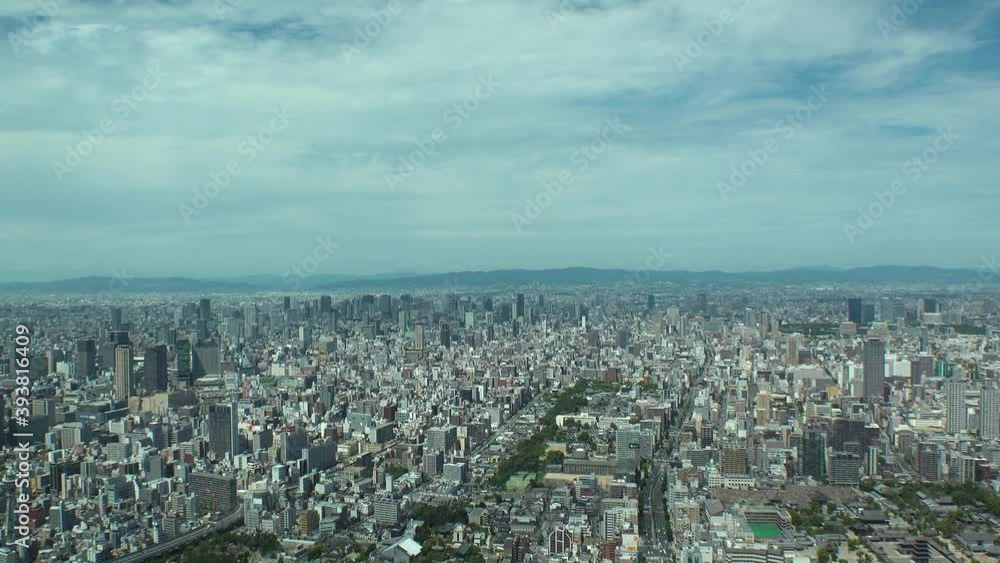 OSAKA, JAPAN : Aerial high angle view of CITYSCAPE of OSAKA in day time. View of buildings and streets around Namba, Shinsaibashi, Umeda and Osaka train station. Wide view time lapse tracking shot.