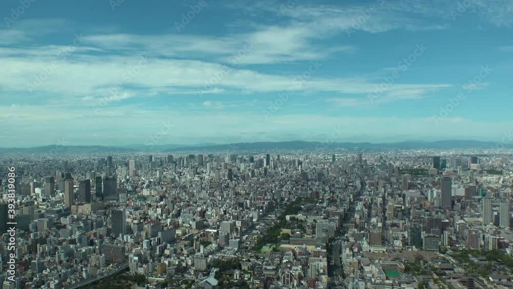 OSAKA, JAPAN : Aerial high angle view of CITYSCAPE of OSAKA in day time. View of buildings and streets around Namba, Shinsaibashi, Umeda and Osaka train station. Wide view time lapse tracking shot. OSAKA, JAPAN : Aerial high angle view of CITYSCAPE of OSAKA in day time. View of buildings and streets around Namba, Shinsaibashi, Umeda and Osaka train station. Wide view time lapse tracking shot.