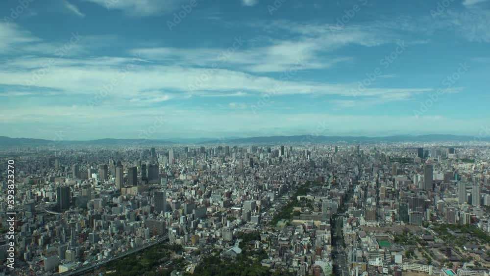 OSAKA, JAPAN : Aerial high angle view of CITYSCAPE of OSAKA in day time. View of buildings and streets around Namba, Shinsaibashi, Umeda and Osaka train station. Wide view time lapse zoom in shot.