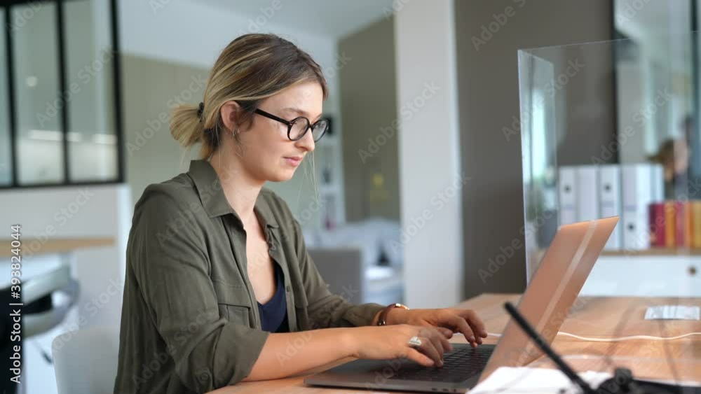 Portrait of blond woman working in open space office Portrait of blond woman working in open space office