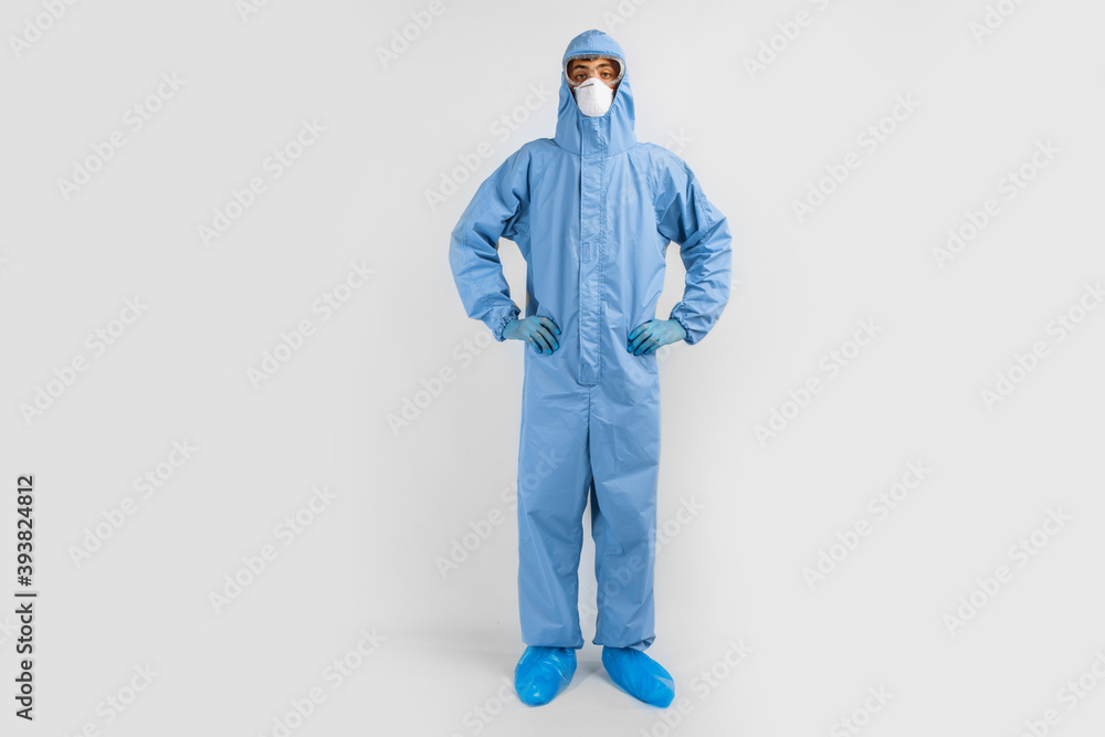 Full-length male doctor in protective clothing, glasses, mask and gloves, on a white background, coronavirus epidemic Full-length male doctor in protective clothing, glasses, mask and gloves, on a white background, coronavirus epidemic