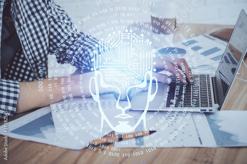 Man typing on keyboard background with brain hologram. Concept of big Data. Double exposure.