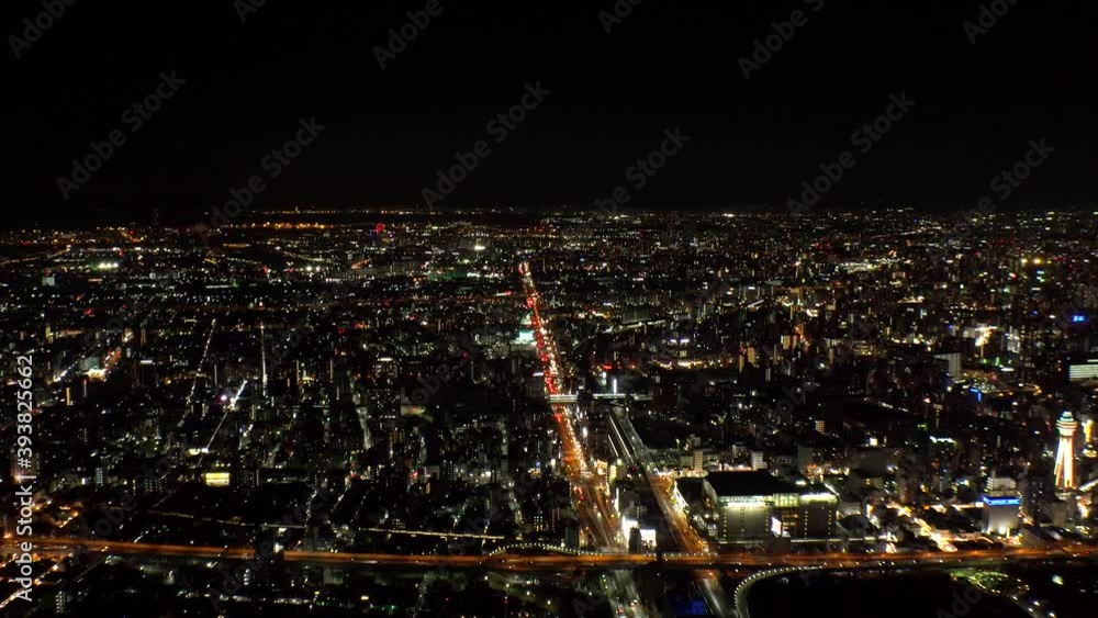 OSAKA, JAPAN : Aerial high angle sunrise view of CITYSCAPE of OSAKA. View of buildings and street traffic around Osaka bay and Kobe port. Long time lapse wide tracking shot, night to morning. OSAKA, JAPAN : Aerial high angle sunrise view of CITYSCAPE of OSAKA. View of buildings and street traffic around Osaka bay and Kobe port. Long time lapse wide tracking shot, night to morning.