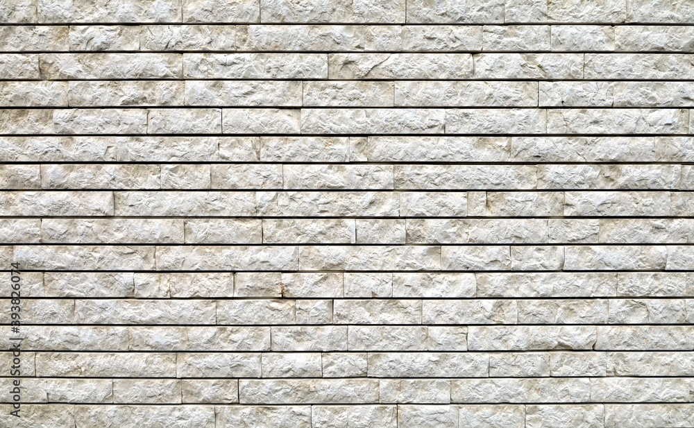Stone wall made of white granite regular bricks. Background and texture Stone wall made of white granite regular bricks. Background and texture