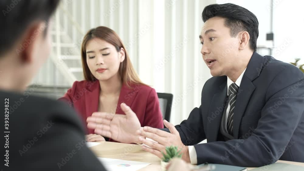 Colleagues business person talking and discussing the issue at business partner team meeting in a modern office Colleagues business person talking and discussing the issue at business partner team meeting in a modern office