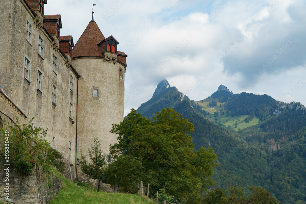 Tower of the castle with mountains in the background, in the village of of Gruyères, Switerland