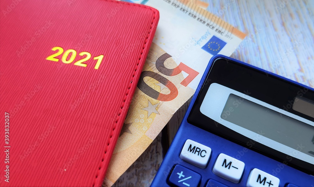 red calendar notebook, fifty euro and calculator red calendar notebook, fifty euro and calculator