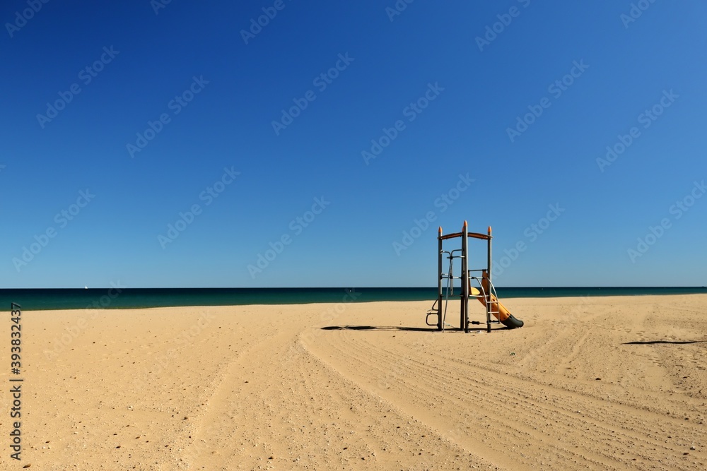 view of a lonely beach with a playground for children at mediterranean sea view of a lonely beach with a playground for children at mediterranean sea