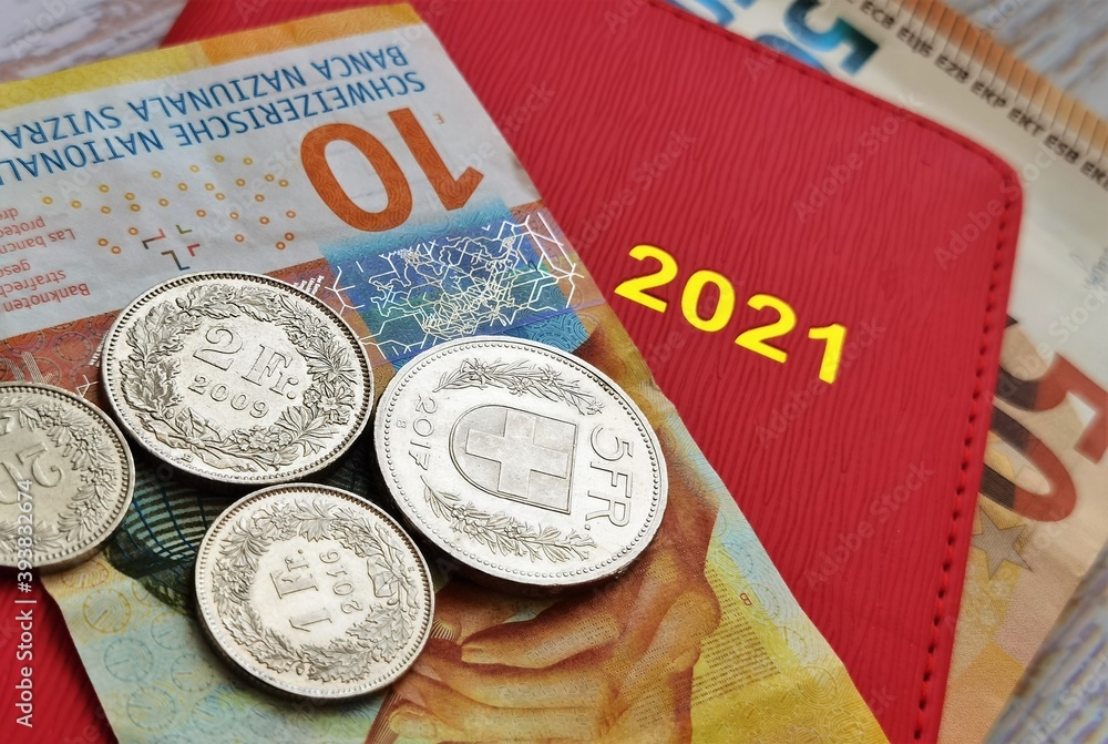 Obraz premium red notepad calendar and swiss and european money