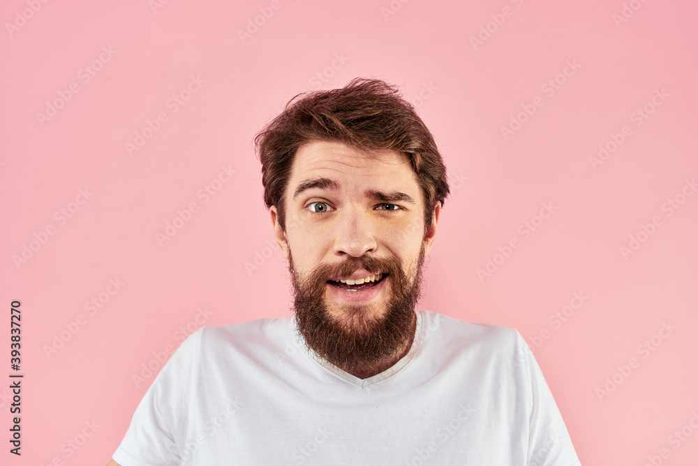 Fototapeta premium Man in white t-shirt gestures with hands emotions lifestyle cropped view pink background