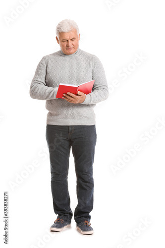 Mature man with book on white background