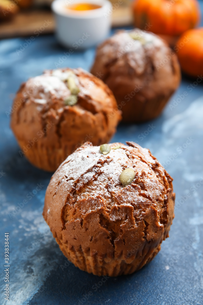 Tasty pumpkin muffins on color background Tasty pumpkin muffins on color background