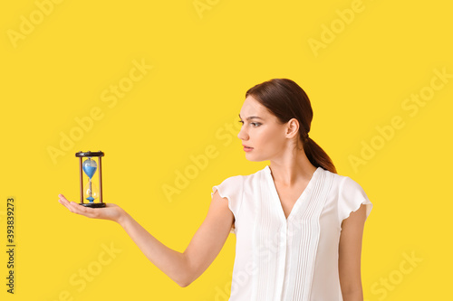 Young woman with hourglass ...