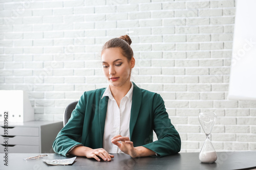 Businesswoman with hourglas...